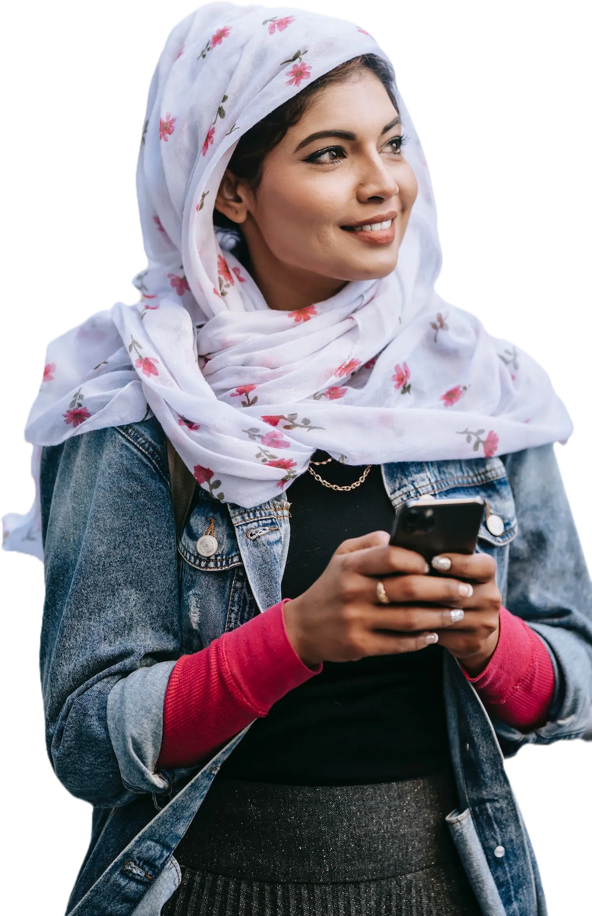 A smiling young woman holding her phone, looking toward the words.
